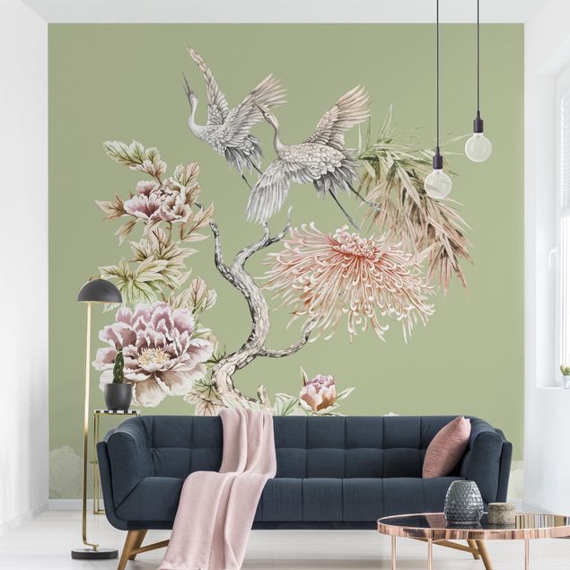 Wanddeko Wohnzimmer Aquarell Störche im Flug mit Blumen auf Grün