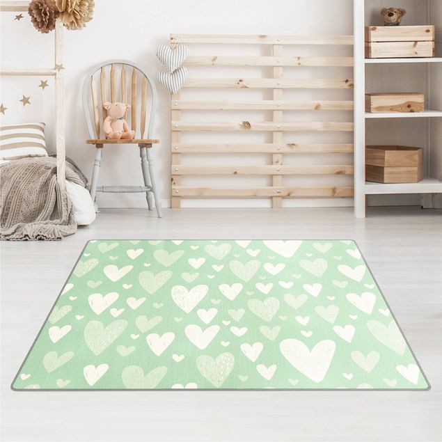 Wanddeko Babyzimmer Kleine und große gezeichnete Weiße Herzen auf Grün