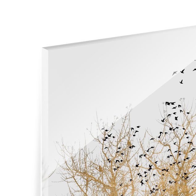 Glasrückwand Küche Vogelschwarm vor goldenem Baum
